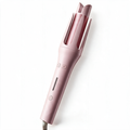 The AERIS Spiral automatic curling iron in pink